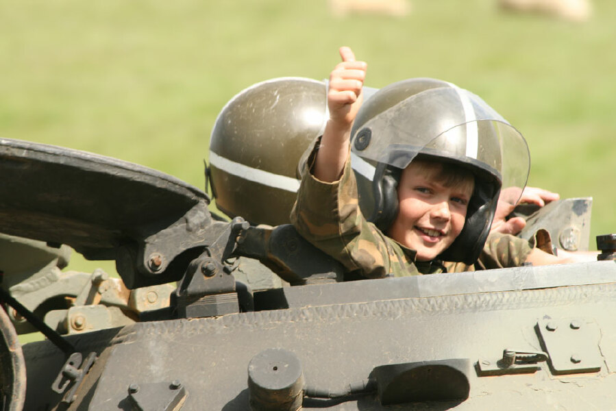 Local School Children dress up as mini-tanks to show support for soldiers fighting in war